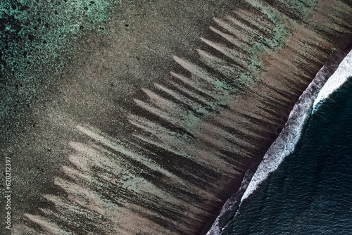 Aerial view of the Ningaloo reef from the sky. Waves and stripes landscape with drone. Beautiful location, Exmouth, Western Australia.