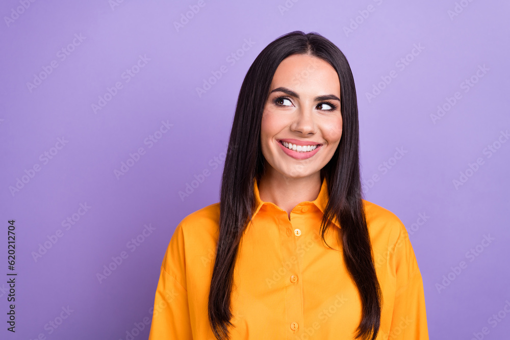 Photo of thoughtful smart business woman wearing orange shirt smiling look empty space brainstorming isolated on purple color background Photo of thoughtful smart business woman wearing orange shirt smiling look empty space brainstorming isolated on purple color background