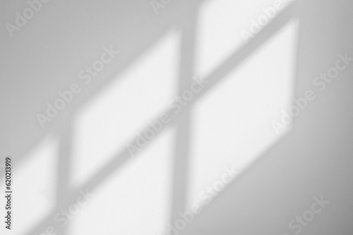 Gray shadow and light blur abstract background on white wall from window. Dark grey shadows indoor in room background, monochrome, shadow overlay effect for backdrop and mockup design