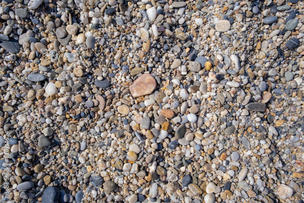 Crushed stone on the seashore. Selective focus on object. The stones were laid on the ground in the garden as a background. Background blur. Pebble stones background. Crushed stone on the seashore. Selective focus on object. The stones were laid on the ground in the garden as a background. Background blur. Pebble stones background.