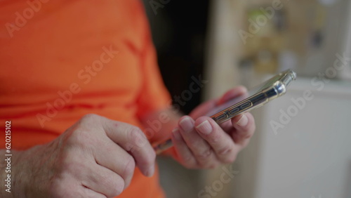 Close-up person hand using phone, older man hands holding cellphone, typing message with finger, touching screen