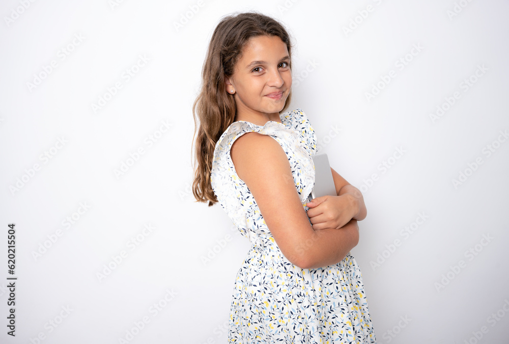 Beautiful little girl holding a tablet in her hands. Online Learning. Portrait isolated on white background. Beautiful little girl holding a tablet in her hands. Online Learning. Portrait isolated on white background.
