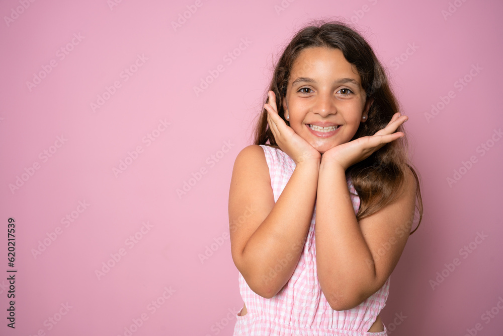 Close up head shot portrait image with smiling little brown-haired girl. Concept happy and beauty kid on pink background, ten year child looking at camera and posing Close up head shot portrait image with smiling little brown-haired girl. Concept happy and beauty kid on pink background, ten year child looking at camera and posing