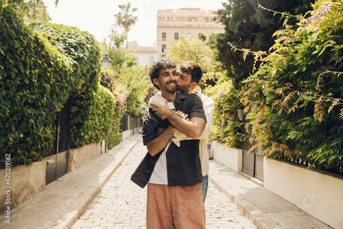 Happy gay couple hugging in the park. LGBT gay couple concept.