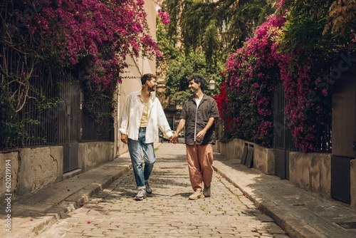 couple walking kissing and huging in the city