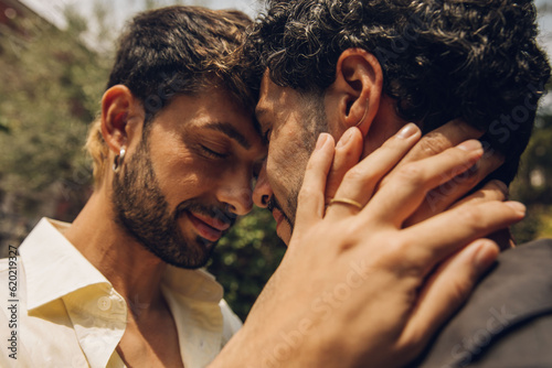 Gay couple in love embracing each other outdoors. Close-up portrait of a gay couple.