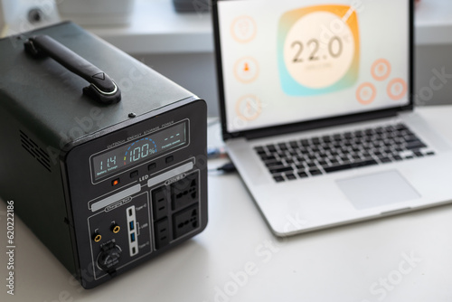 Wallpaper Mural Portable power station charging devices on floor in living room Torontodigital.ca