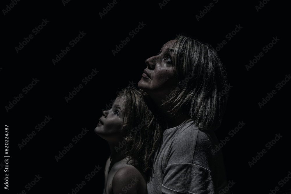 a girl with a child in the dark looking up a girl with a child in the dark looking up