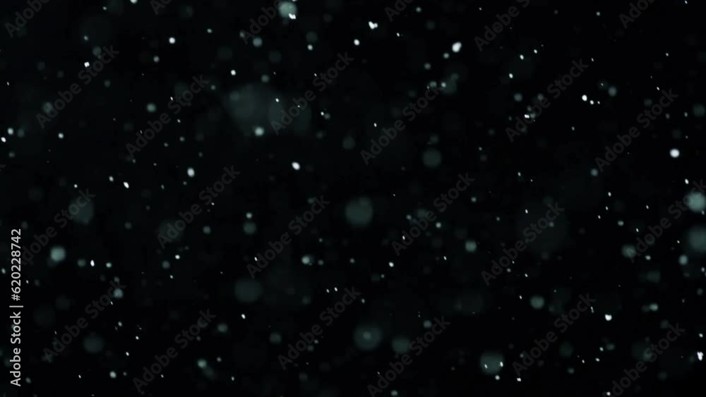 Fast-falling dust particles on a black background Fast-falling dust particles on a black background
