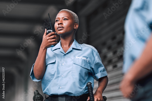 Bild auf Leinwand Police, communication and black woman law enforcement worker talking on walkie talkie or radio for emergency