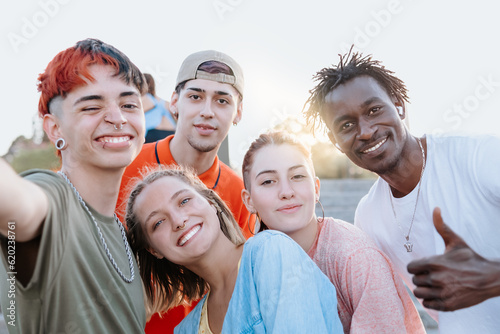 Cheese! Young multiracial millennial friends capture fun moments with a selfie