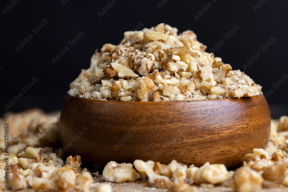 Crushed dried walnuts on the table Crushed dried walnuts on the table