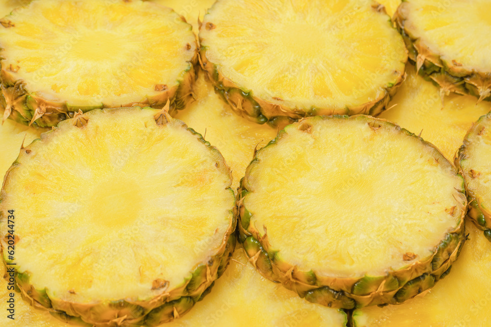 Pineapple juicy yellow slices as a background. Pineapple juicy yellow slices as a background.