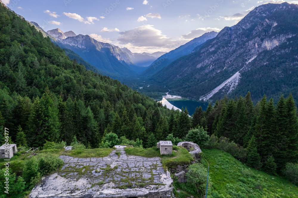 Alpine landscape with green forest in Predil Pass, Italy. Aerial drone view