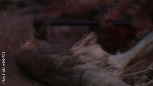 man with axe cutting firewood in desert 