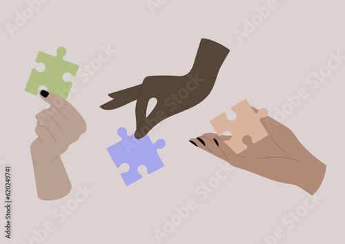 A teamwork concept, hands holding colorful pieces of puzzle