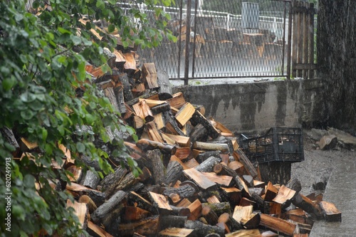firewood in a pile in the rain