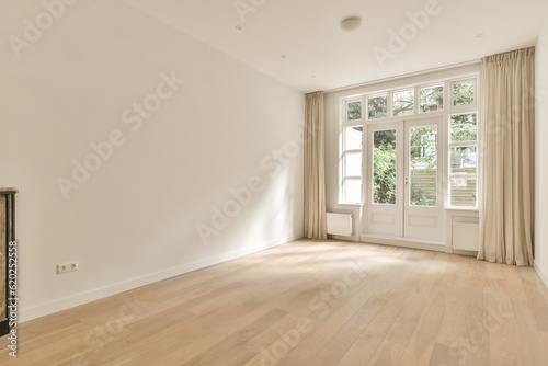 an empty living room with wood flooring and large windows in the room is very clean, but it's all white