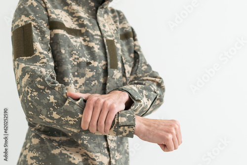 A military man has a pain in his arm.