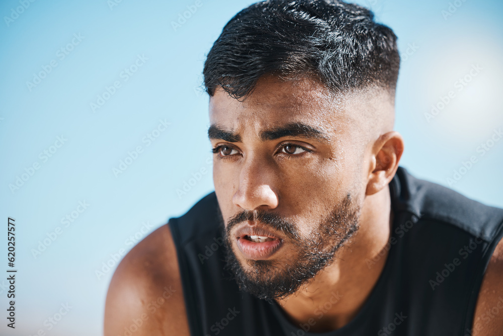 Fototapeta premium Fitness, break and tired man outdoor breathing, rest and relax after training, workout or running. Face, breathe and Indian male runner stop to recover from exercise, challenge or sports performance