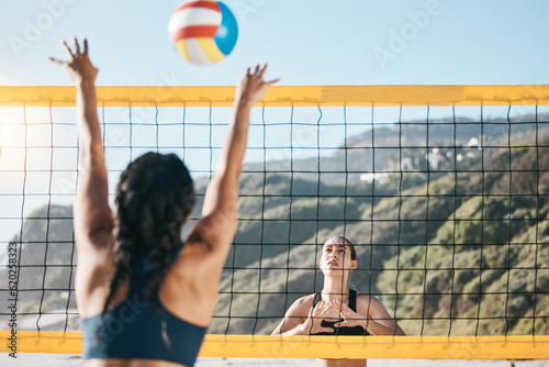 Volleyball, women and spike, net with sports and fitness outdoor, playing game at the beach at summer. Exercise, female athlete and match with ball and active, workout and action with tournament