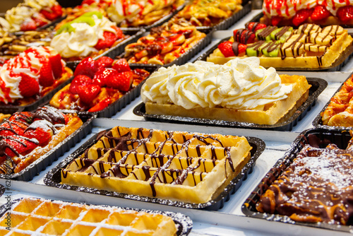 Belgian waffles with colorful sweet toppings and fruits for sale in Brussels, Belgium