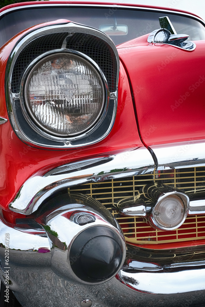 Retro styled image of a front of a red classic American car.