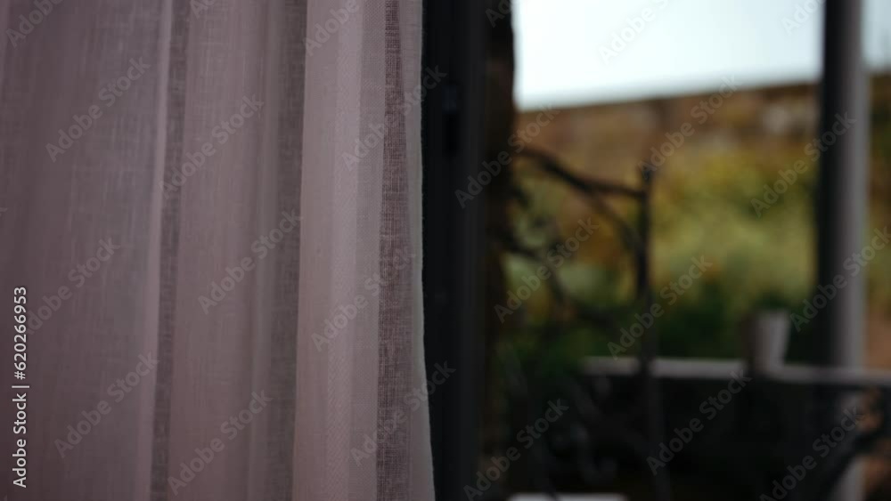Curtains reveal patio view of countryside hotel Curtains reveal patio view of countryside hotel
