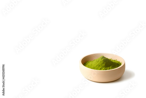 Green matcha tea powder in a wooden bowl