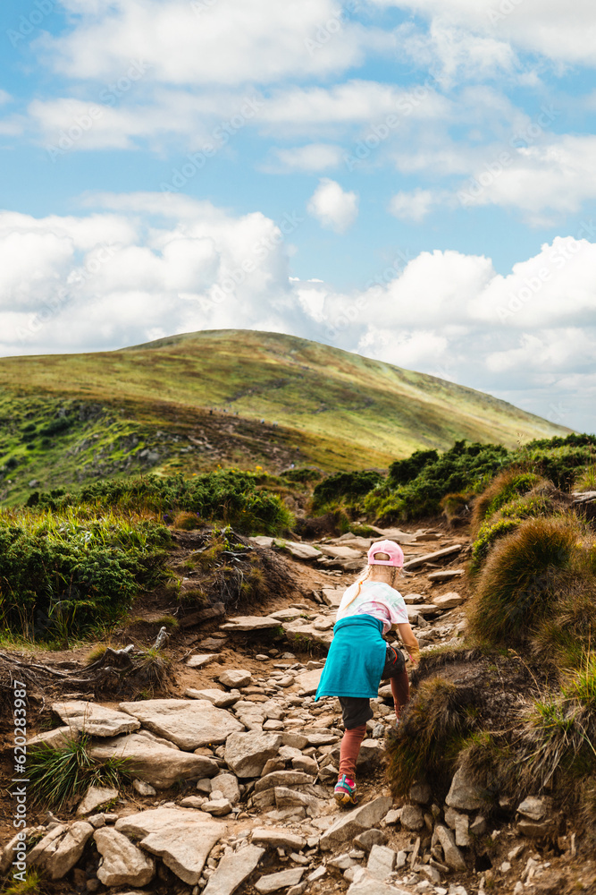 A girl climbs a mountain
