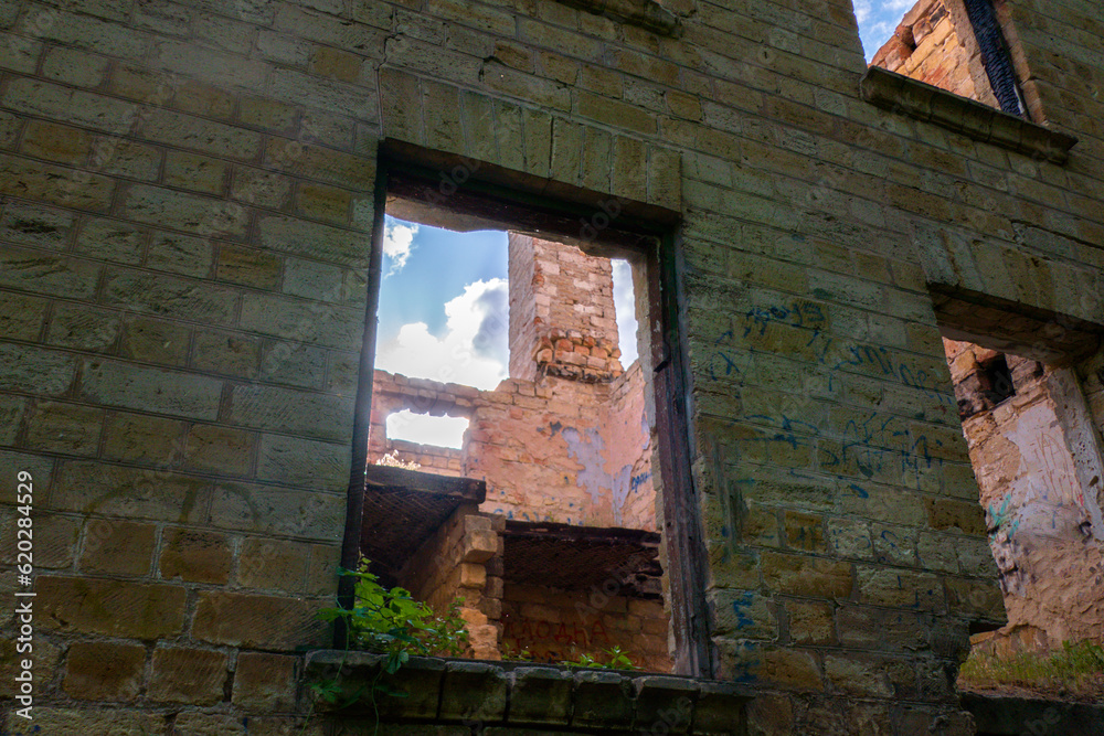 Empty windows of a destroyed brick building.