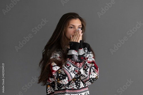 a young girl in a warm sweater is freezing at home in winter