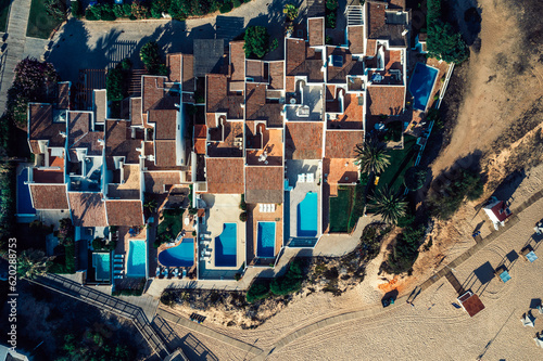 Aerial drone top down view of luxurious residences in Vale do Lobo, iconic beachfront resort and home, near Quarteira in Algarve, Portugal photo
