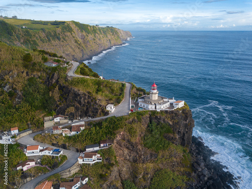 Aerial view of Farol do Arnel lighthouse and fishermen huts, Sao Miguel island, Azores, Portugal, Atlantic photo