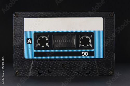 Old vintage audio cassette close up on a black background photo