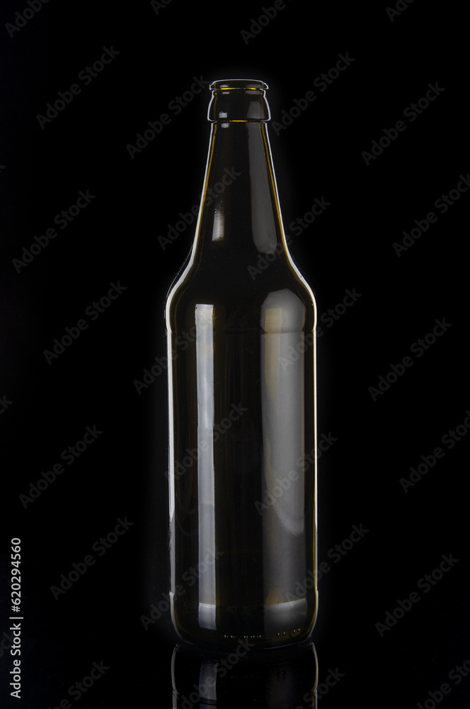 Empty beer bottle close up on black background Empty beer bottle close up on black background
