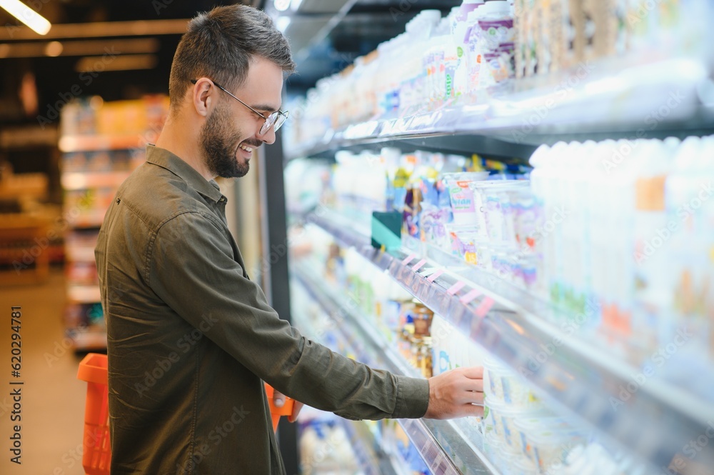 Handsome man shopping in a supermarket Handsome man shopping in a supermarket