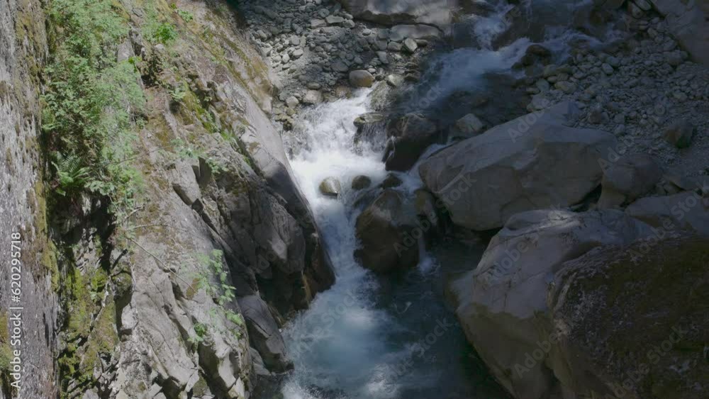 Cold and fast mountain river passing around rock and making white foam swirls. Hinterrhein River, Roffla Gorge, Rofflaschlucht. Andeer, Canton of Graubünden in Switzerland Cold and fast mountain river passing around rock and making white foam swirls. Hinterrhein River, Roffla Gorge, Rofflaschlucht. Andeer, Canton of Graubünden in Switzerland