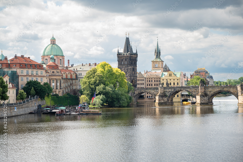 Scenic view on Vltava rive, Charles bridge and historical center of Prague, buildings and landmarks of old town at sunset, Prague, Czech Republic

