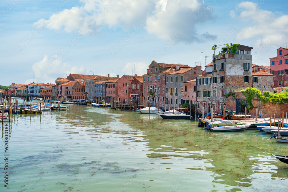 Boatyard with many boats on the water in Venice, Italy. Scenic landscape in Venice.