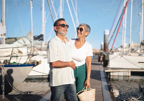 Senior Sailboat Owners Couple Standing Near Yachts At Marina Port