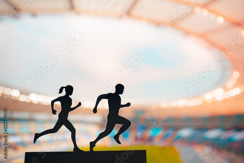 Running as One: Silhouettes of Male and Female Runners Unite, Elegantly Blending their Energies in Front of a Modern Sports Stadium
