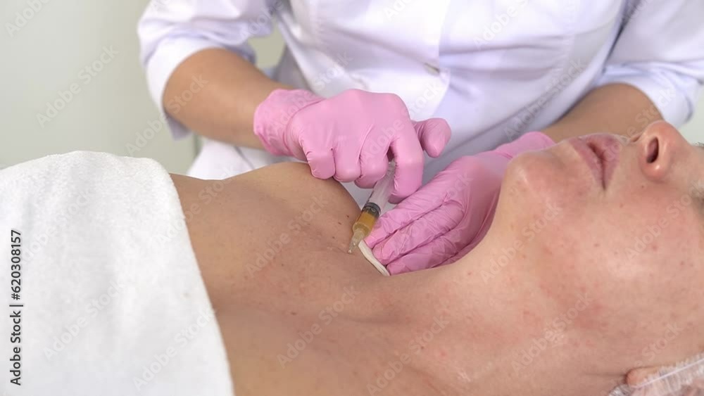 Cosmetologist makes prp-therapy against aging of the skin of the neck and decollete of an adult woman Real procedure. The concept of cosmetology. Cosmetologist makes prp-therapy against aging of the skin of the neck and decollete of an adult woman Real procedure. The concept of cosmetology.