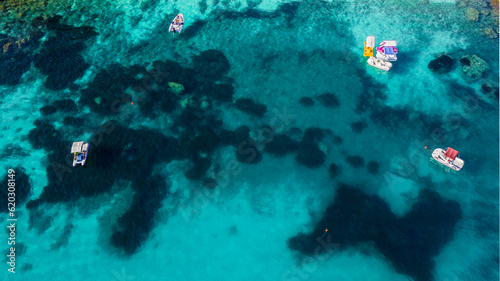 aerial view from the drone of a crystal clear Caribbean sea with boats that seem to fly. this image gives a sense of peace and tranquility immersed in unspoiled nature