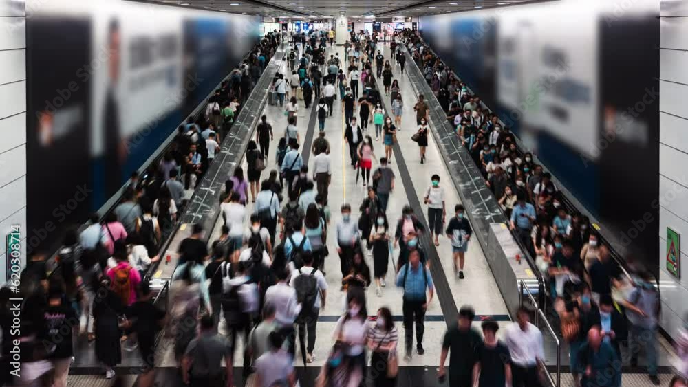 Timelapse of Asian people walk on travelator escalator at Central subway underground station in Hong Kong. Public transportation, Asia city life, or commuter urban lifestyle concept. High angle view