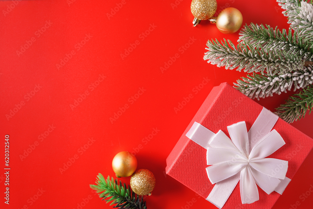 Festive Christmas ornaments and decorations on red background.