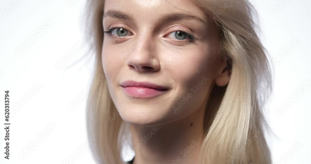 Radiant smile and mesmerizing gaze of a Caucasian woman in this striking close-up portrait against a pristine white background, she stands with poise and confidence, her eyes locked onto the camera Radiant smile and mesmerizing gaze of a Caucasian woman in this striking close-up portrait against a pristine white background, she stands with poise and confidence, her eyes locked onto the camera