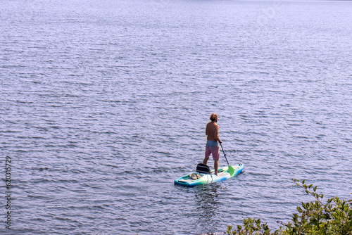 man paddle boarding on lake