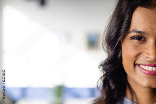 Half portrait of happy middle eastern casual businesswoman in office with copy space