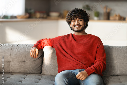Portrait Of Handsome Young Indian Man Posing In Home Interior